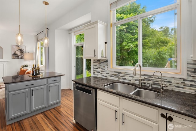23618 Carter Rd, Bothell, WA 98021 - kitchen featuring stainless steel dishwasher, tasteful backsplash, dark wood-style floors, dark stone countertops, and hanging light fixtures