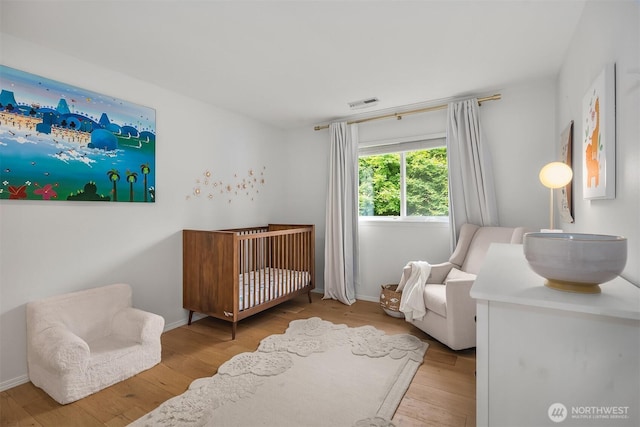 23618 Carter Rd, Bothell, WA 98021 - bedroom with a crib and wood finished floors