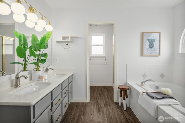 23618 Carter Rd, Bothell, WA 98021 - full bathroom with double vanity, wood finished floors, a bath, and a shower stall
