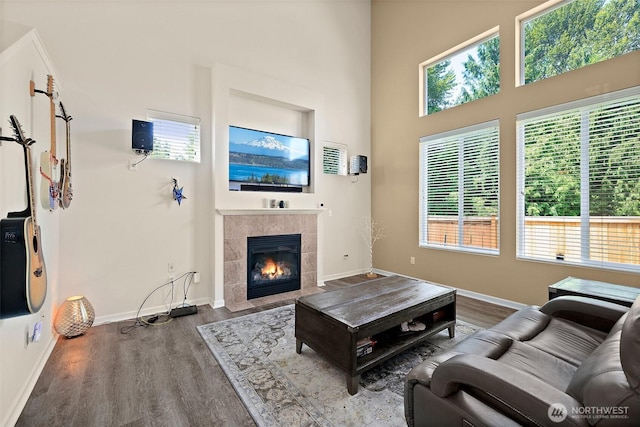 16922 SE 262nd St, Covington, WA 98042 - living room featuring wood finished floors, a tile fireplace, and a high ceiling