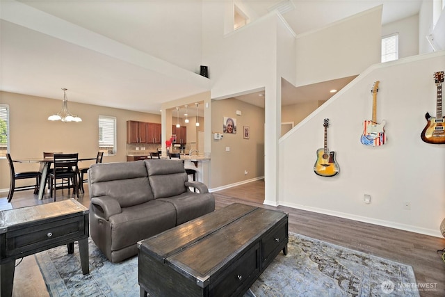 16922 SE 262nd St, Covington, WA 98042 - living room with wood finished floors, a chandelier, and healthy amount of natural light