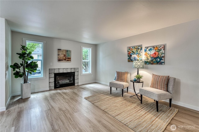 3939 10th St SE Unit C6, Puyallup, WA 98374 - living area with healthy amount of natural light, wood finished floors, and a tiled fireplace