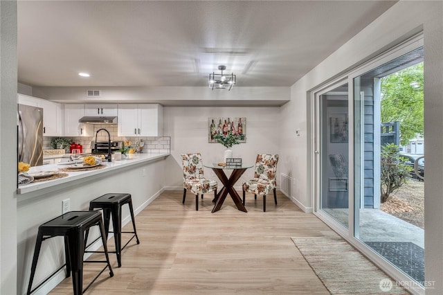 3939 10th St SE Unit C6, Puyallup, WA 98374 - dining room featuring light wood finished floors and recessed lighting