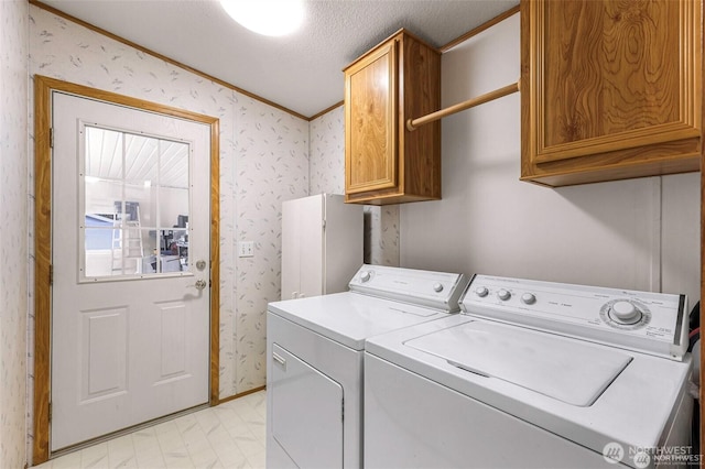 921 Autumn Ln Unit 221, Bellingham, WA 98229 - laundry area featuring cabinet space, wallpapered walls, separate washer and dryer, and crown molding