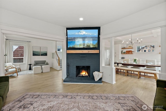 3209 S 8th St, Tacoma, WA 98405 - living area featuring a chandelier, wood finished floors, a brick fireplace, and recessed lighting