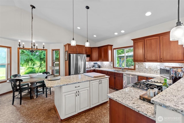19838 Bear View Ln SW, Rochester, WA 98579 - kitchen featuring appliances with stainless steel finishes, a chandelier, decorative backsplash, light stone counters, and recessed lighting
