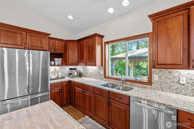 19838 Bear View Ln SW, Rochester, WA 98579 - kitchen with stainless steel appliances, vaulted ceiling, backsplash, brown cabinets, and recessed lighting