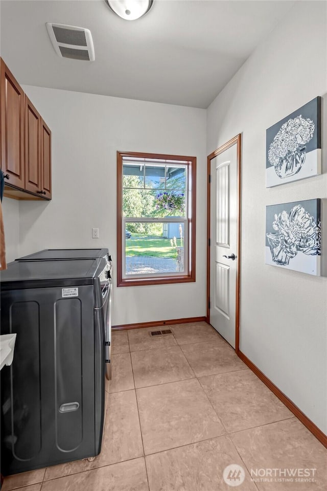 19838 Bear View Ln SW, Rochester, WA 98579 - washroom with cabinet space, washer and clothes dryer, and light tile patterned floors