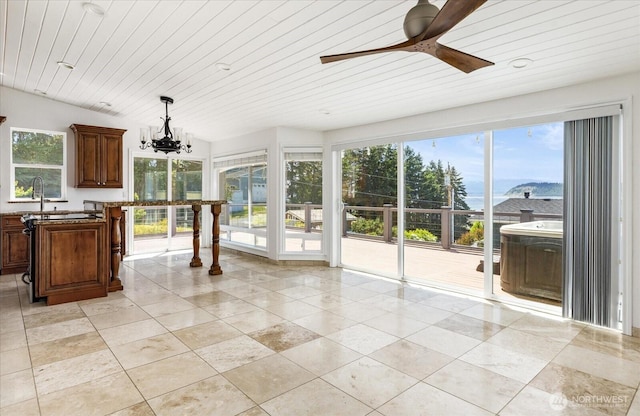 2735 Evening Glory Ct, Clinton, WA 98236 - kitchen featuring a chandelier, hanging light fixtures, light tile patterned floors, a ceiling fan, and stone counters