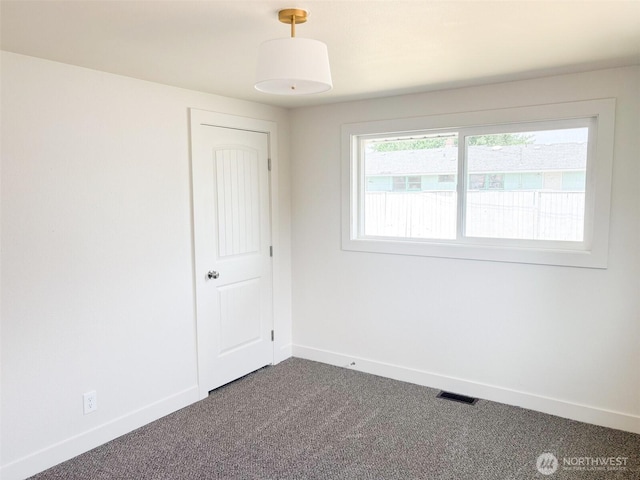 308 N Dale Rd, Moses Lake, WA 98837 - empty room featuring dark colored carpet and baseboards