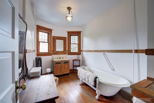906 E Shelby St, Seattle, WA 98102 - bathroom featuring a freestanding tub, vanity, and hardwood / wood-style floors