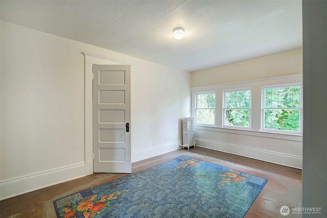 906 E Shelby St, Seattle, WA 98102 - empty room with radiator heating unit and hardwood / wood-style floors