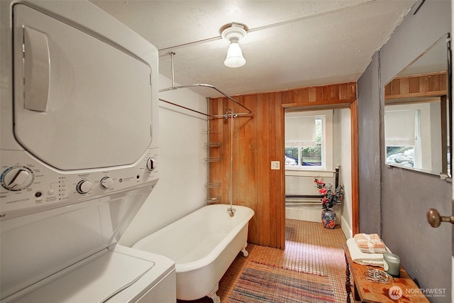 906 E Shelby St, Seattle, WA 98102 - bathroom featuring stacked washing machine and dryer, tile patterned floors, and wood walls