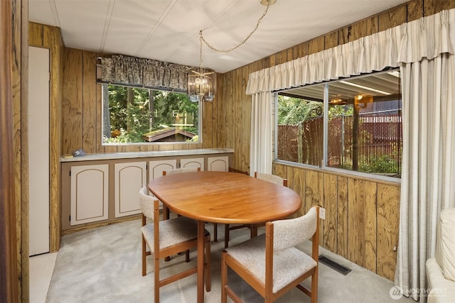 827 211th Pl NE, Sammamish, WA 98074 - dining space featuring healthy amount of natural light, light colored carpet, a chandelier, and wooden walls