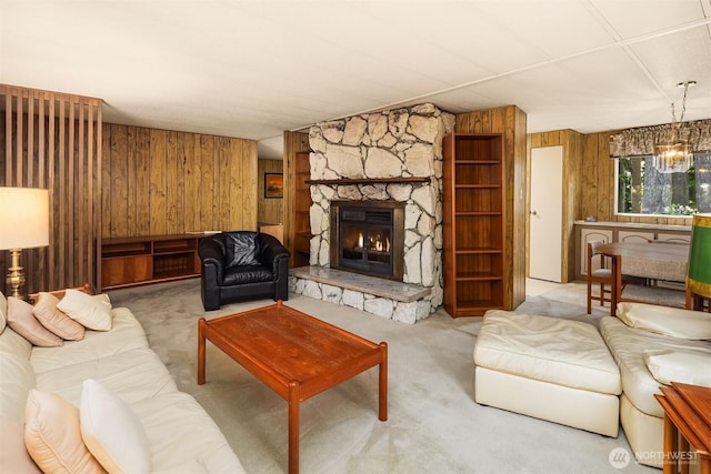 827 211th Pl NE, Sammamish, WA 98074 - living area with wood walls, carpet, a stone fireplace, and a chandelier