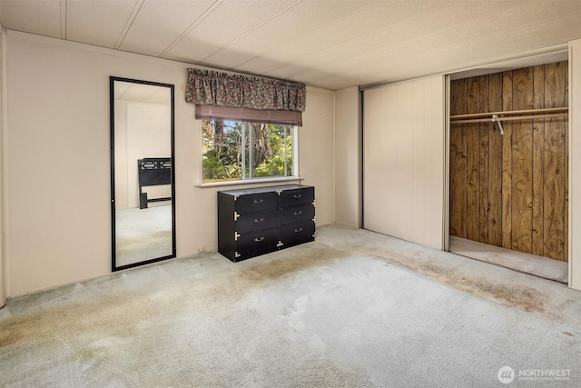 827 211th Pl NE, Sammamish, WA 98074 - unfurnished bedroom with carpet, a closet, and wooden walls