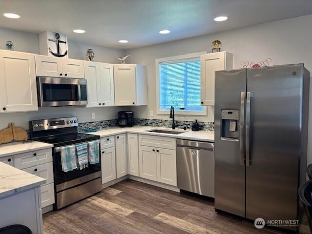 163 Wishkah St SW, Ocean Shores, WA 98569 - kitchen featuring stainless steel appliances, white cabinets, dark wood finished floors, light stone counters, and recessed lighting