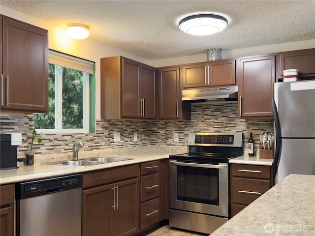 17714 Robinhood Ln, Snohomish, WA 98290 - kitchen featuring appliances with stainless steel finishes, under cabinet range hood, light countertops, and a textured ceiling