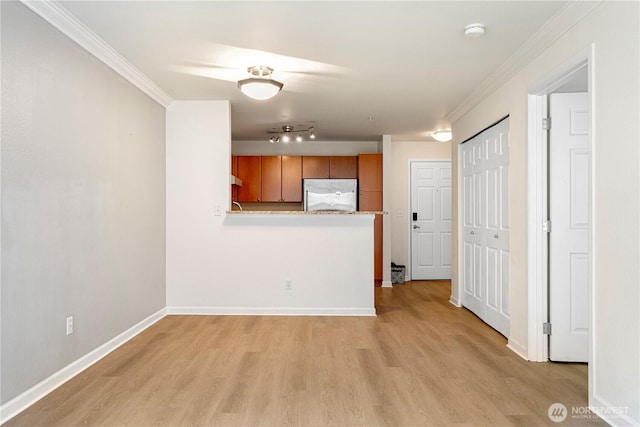 621 5th Ave N Unit 103, Seattle, WA 98109 - unfurnished living room featuring light wood-type flooring, ornamental molding, and track lighting