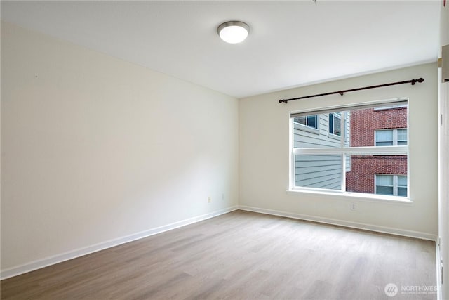 621 5th Ave N Unit 103, Seattle, WA 98109 - empty room featuring wood finished floors and baseboards