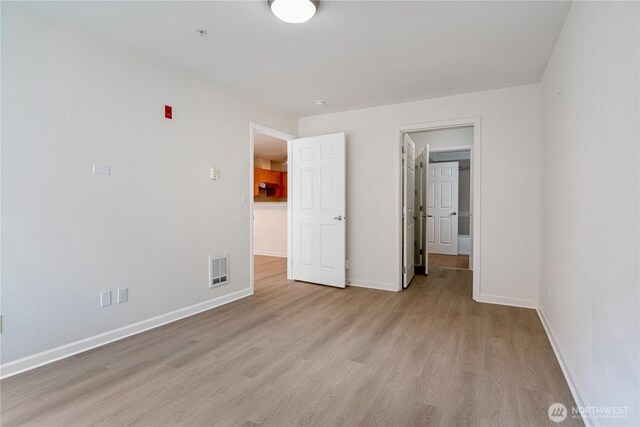 621 5th Ave N Unit 103, Seattle, WA 98109 - unfurnished bedroom with light wood finished floors and baseboards