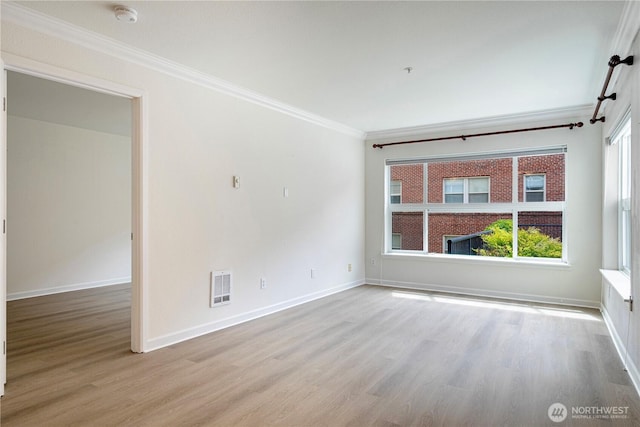 621 5th Ave N Unit 103, Seattle, WA 98109 - spare room with a smoke detector, ornamental molding, wood finished floors, and healthy amount of natural light