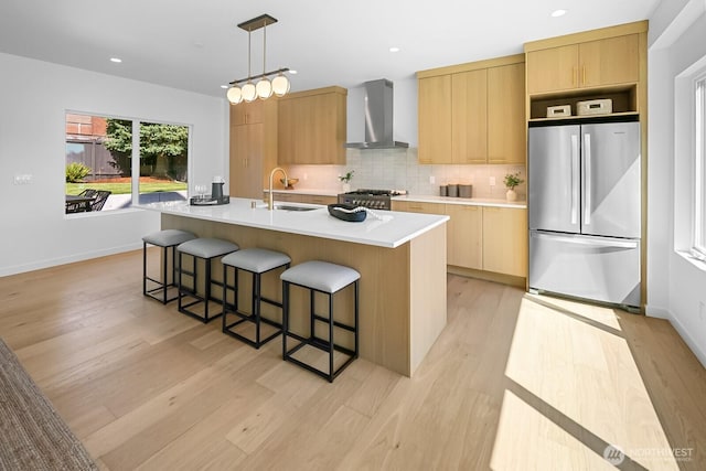 10339 11th Ave NW, Seattle, WA 98177 - kitchen with freestanding refrigerator, wall chimney range hood, light brown cabinetry, light wood-style flooring, and modern cabinets