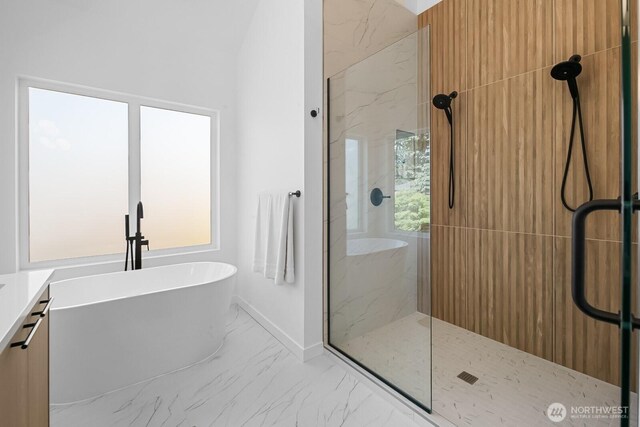 10339 11th Ave NW, Seattle, WA 98177 - full bathroom featuring marble look tiles, a marble finish shower, a freestanding bath, and vanity