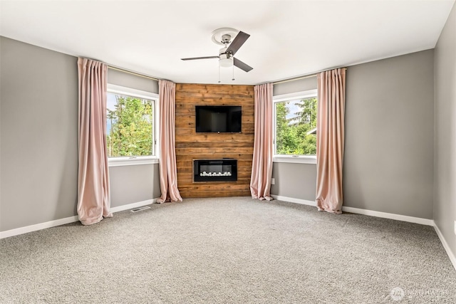 233 Joann Ln, Arlington, WA 98223 - unfurnished living room with a ceiling fan, plenty of natural light, a fireplace, and carpet