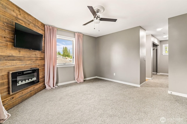 233 Joann Ln, Arlington, WA 98223 - unfurnished living room featuring carpet, ceiling fan, and a glass covered fireplace