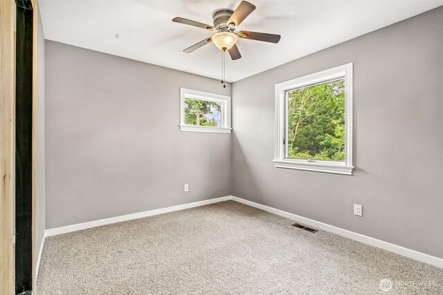 233 Joann Ln, Arlington, WA 98223 - spare room featuring ceiling fan and carpet