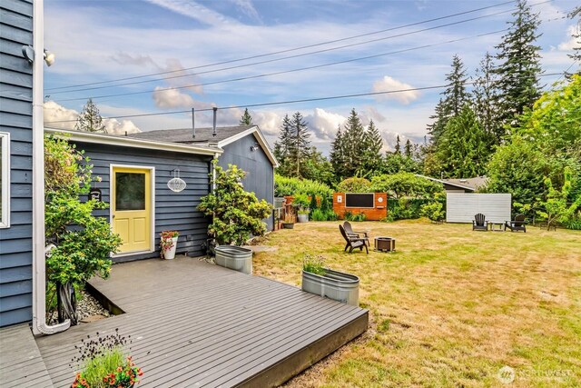 233 Joann Ln, Arlington, WA 98223 - wooden terrace with a lawn, a fire pit, and a storage unit