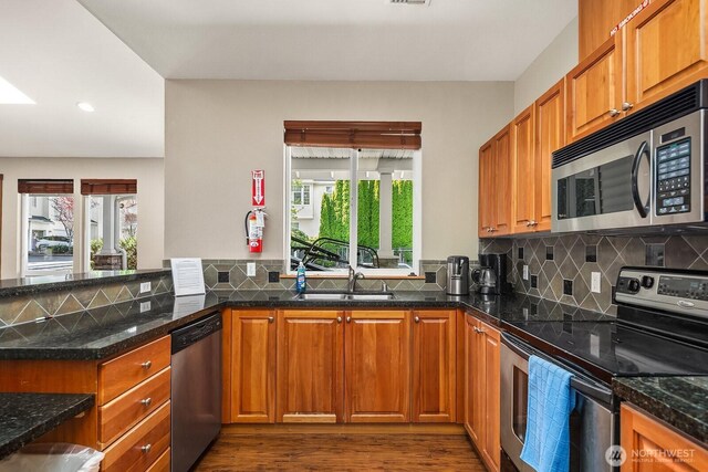 1855 Trossachs Blvd SE Unit 1401, Sammamish, WA 98075 - kitchen with appliances with stainless steel finishes, dark wood-style flooring, recessed lighting, tasteful backsplash, and brown cabinets