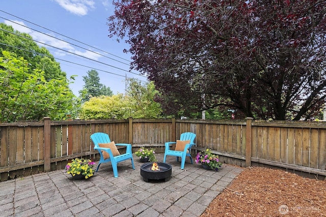 9400 35th Ave SW, Seattle, WA 98126 - fenced backyard with an outdoor fire pit and a patio area