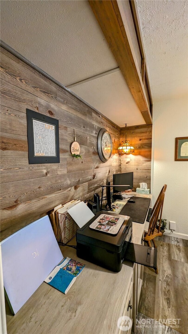 1215 273rd Pl, Ocean Park, WA 98640 - dining area featuring wooden walls, wood finished floors, a textured ceiling, and a desk