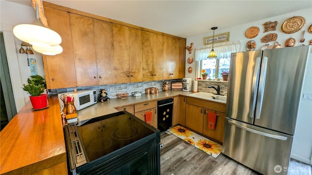 1215 273rd Pl, Ocean Park, WA 98640 - kitchen with freestanding refrigerator, dishwasher, white microwave, electric range, and decorative backsplash