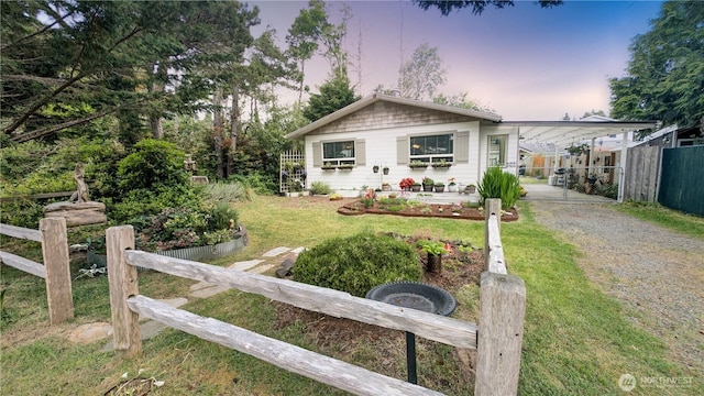 1215 273rd Pl, Ocean Park, WA 98640 - view of front facade with dirt driveway, a carport, and a gate