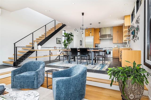 2501 Yale Ave E, Seattle, WA 98102 - living room with stairway, wood finished floors, recessed lighting, and a chandelier