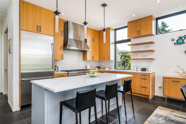 2501 Yale Ave E, Seattle, WA 98102 - kitchen with wall chimney exhaust hood, stainless steel built in refrigerator, tasteful backsplash, open shelves, and light stone counters