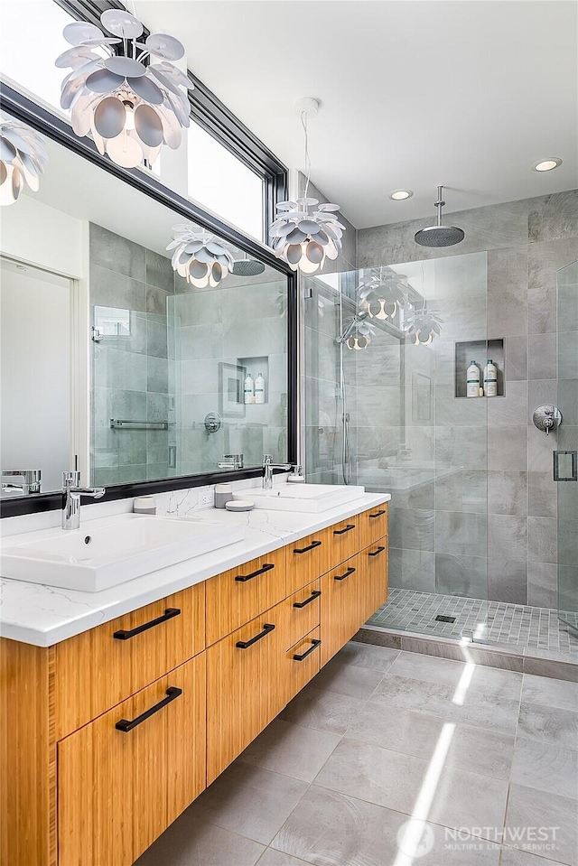 2501 Yale Ave E, Seattle, WA 98102 - bathroom featuring a chandelier, double vanity, a stall shower, tile patterned floors, and recessed lighting