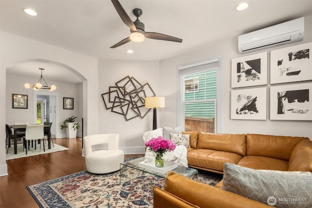 325 23rd Ave E, Seattle, WA 98112 - living room featuring an AC wall unit, arched walkways, a chandelier, recessed lighting, and wood finished floors