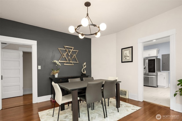 325 23rd Ave E, Seattle, WA 98112 - dining area with electric panel, a chandelier, and wood finished floors