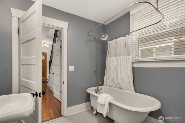 325 23rd Ave E, Seattle, WA 98112 - full bathroom with a freestanding tub, a shower with curtain, and tile patterned floors