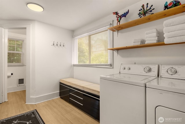 325 23rd Ave E, Seattle, WA 98112 - washroom with washer and dryer, light wood-style flooring, plenty of natural light, and heating unit