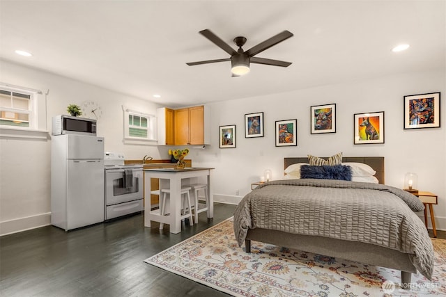 325 23rd Ave E, Seattle, WA 98112 - bedroom featuring freestanding refrigerator, recessed lighting, multiple windows, and dark wood finished floors