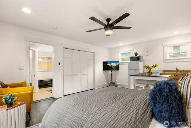 325 23rd Ave E, Seattle, WA 98112 - bedroom featuring freestanding refrigerator, wood finished floors, recessed lighting, a closet, and ceiling fan