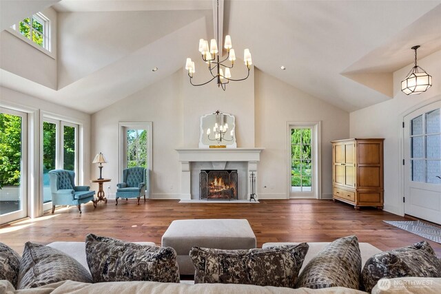 303 39th Ave NE, Olympia, WA 98506 - living area with a chandelier, high vaulted ceiling, healthy amount of natural light, and wood finished floors