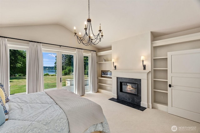 303 39th Ave NE, Olympia, WA 98506 - carpeted bedroom featuring a chandelier, a water view, vaulted ceiling, a premium fireplace, and access to exterior