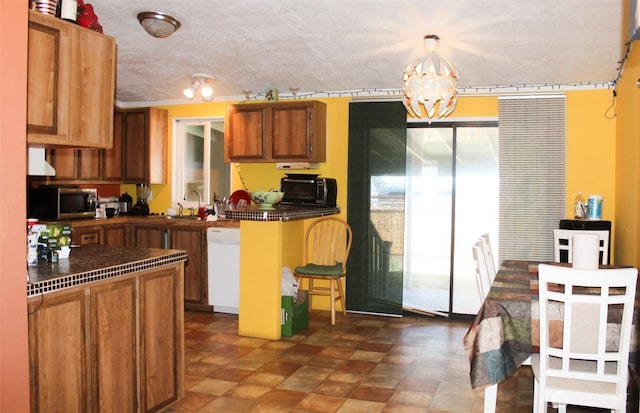 5705 Littlerock Rd SW Unit 41, Tumwater, WA 98512 - kitchen featuring dishwasher, stainless steel microwave, dark countertops, a chandelier, and brown cabinetry