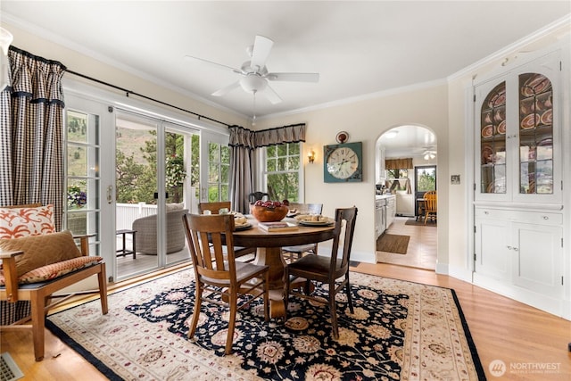 3A Ross Rd, Twisp, WA 98856 - dining room with a ceiling fan, arched walkways, crown molding, and light wood finished floors